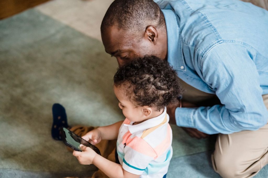 Parent and child using a smartphone together